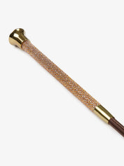 Close-up view of the handle on the espresso LeMieux Brilliance Baton Whip on a white background