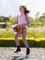 Child riding the LeMieux Mini Hobby Horse in a palomino color outside