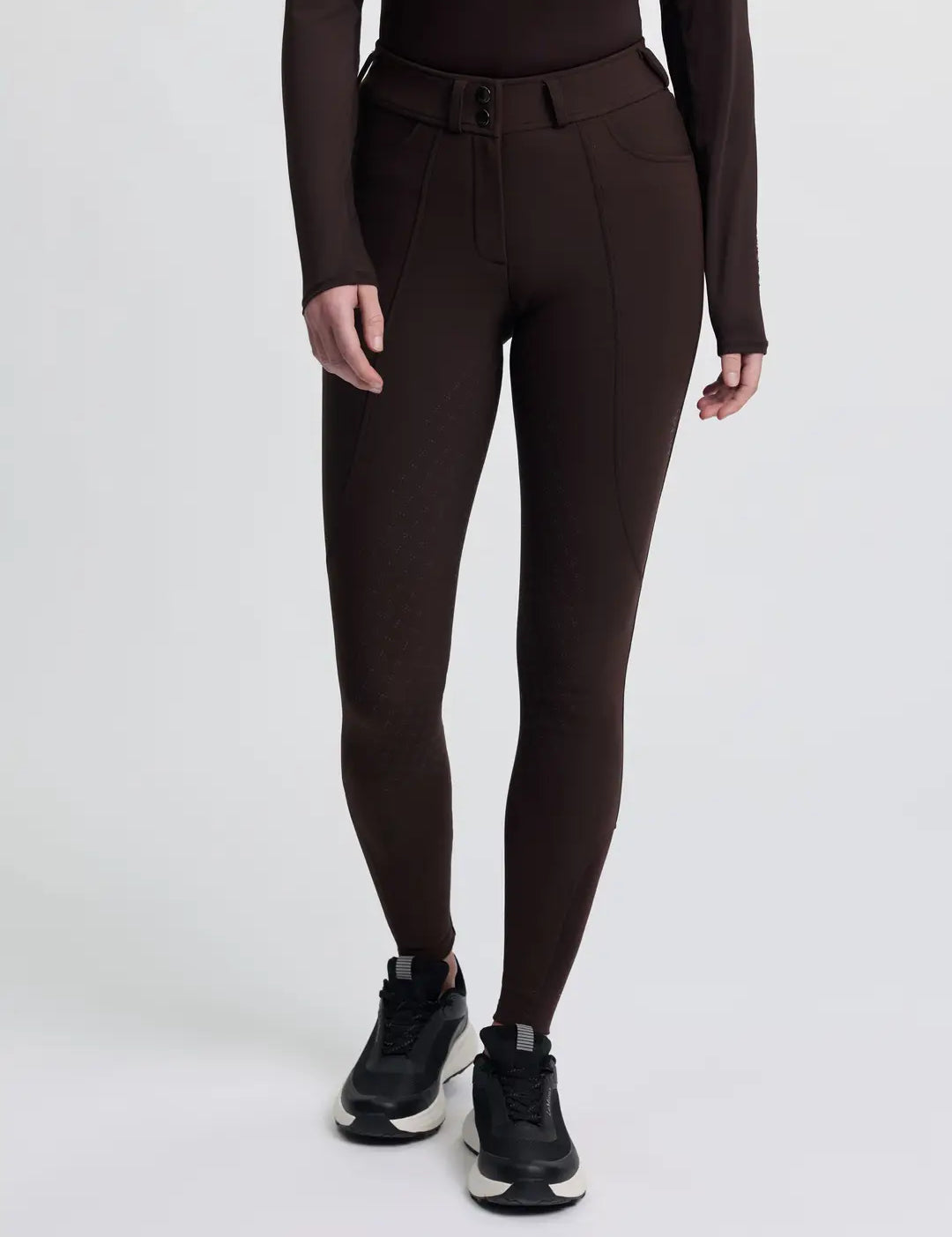 Front view of a model wearing the brown LeMieux Brilliance Full Seat Breeches on a plain background