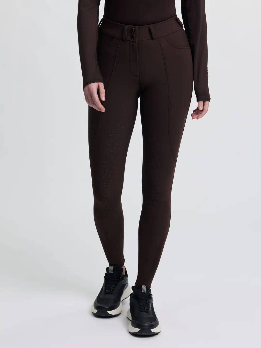 Front view of a model wearing the brown LeMieux Brilliance Full Seat Breeches on a plain background