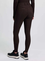 Back view of a model wearing the brown LeMieux Brilliance Full Seat Breeches on a plain background