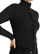 Angled front view of a model wearing the Horze Viveka Womens Perforated Training Jacket in black on a white background
