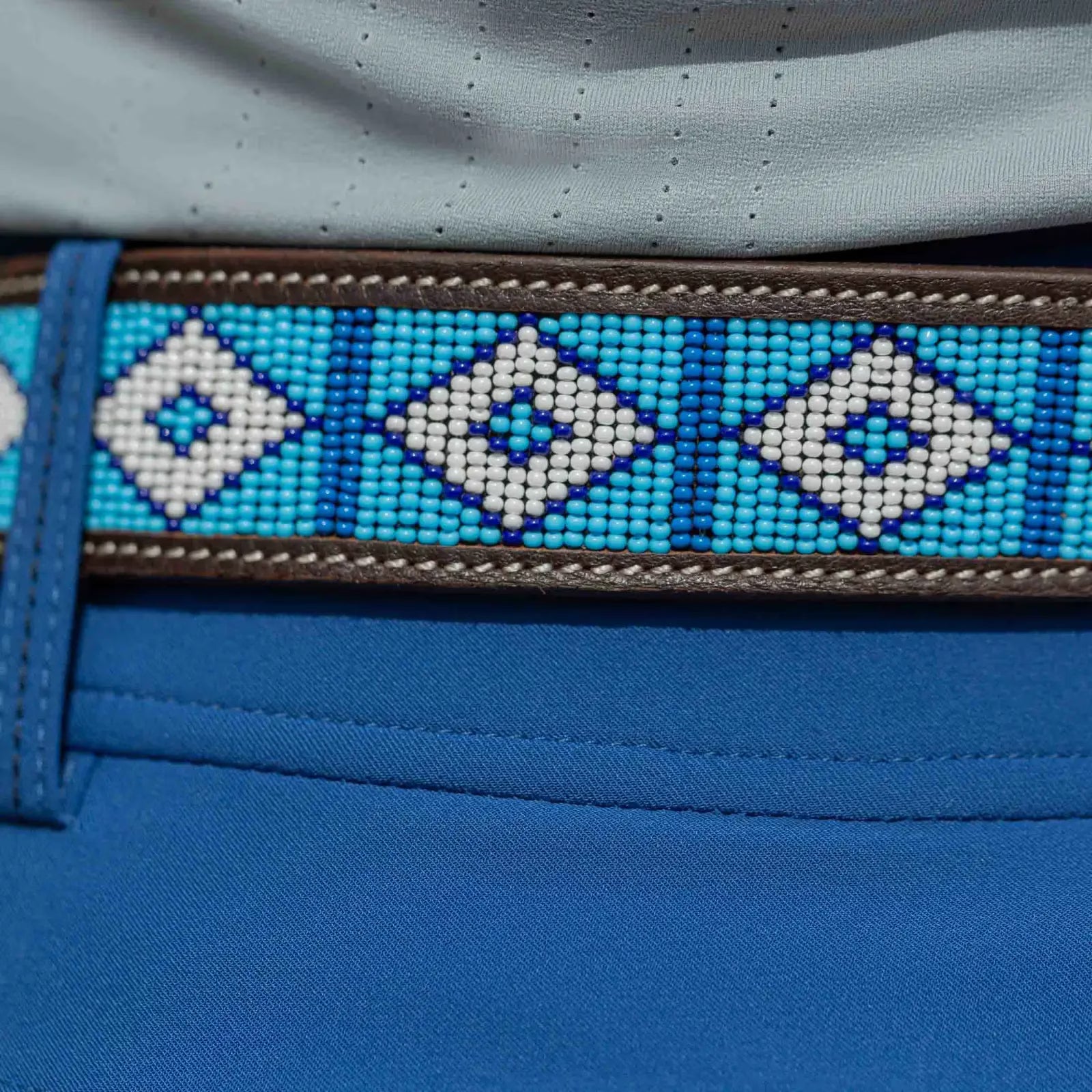 Close-up view of the dark brown leather Equinavia Estelle Hand Beaded Belt with blue and white beading