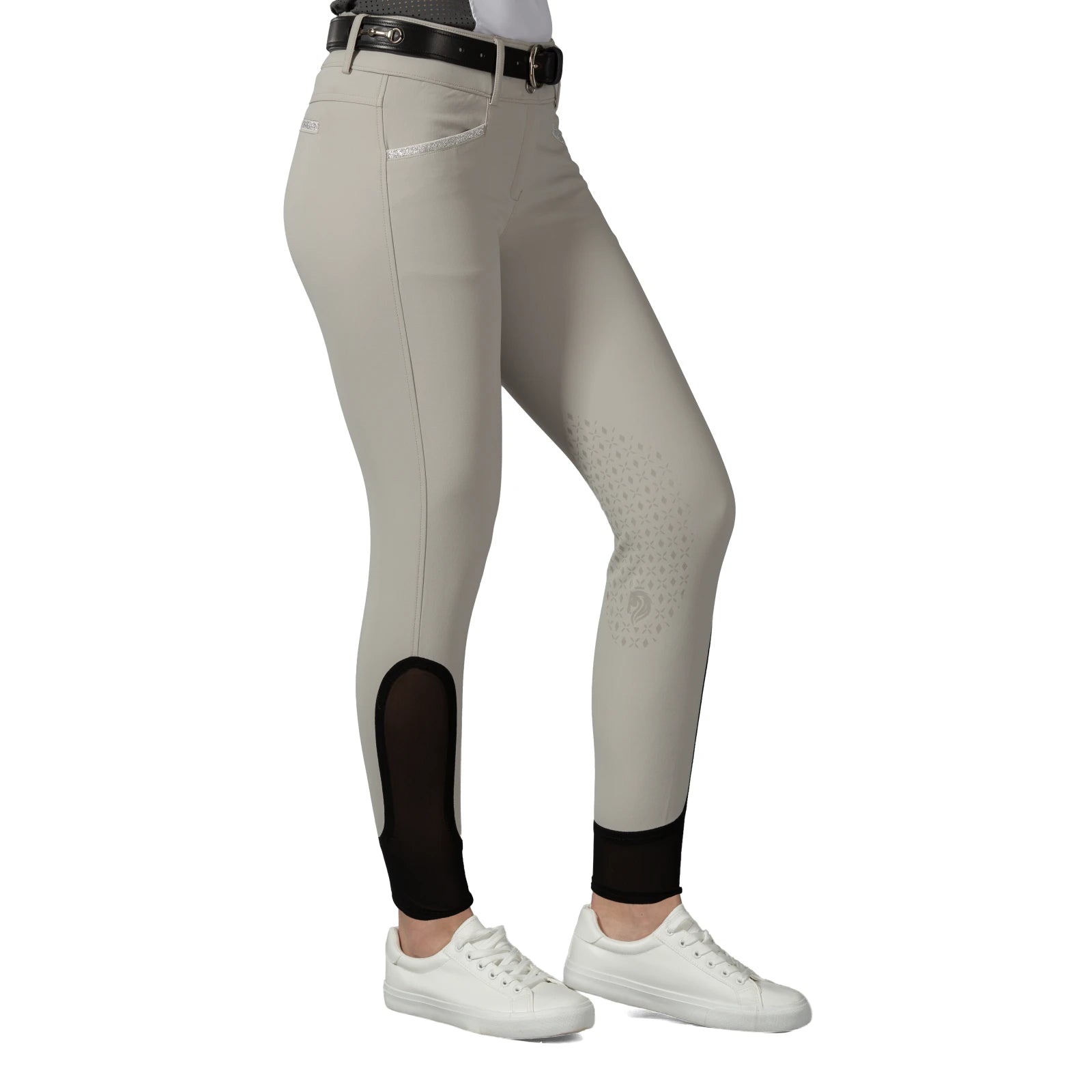 Side view of a model wearing the tan Equinavia Kristina Knee Patch Breeches on a white background