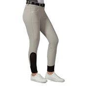 Side view of a model wearing the tan Equinavia Kristina Knee Patch Breeches on a white background