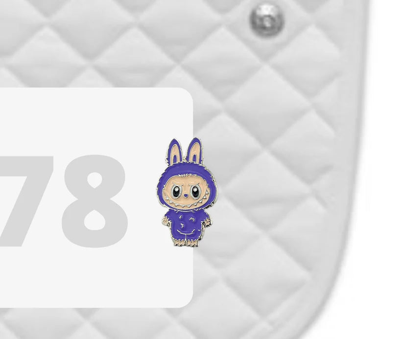 Side view of a white pad with numbers 378 and a Labubu Dubois Cheval Number Pin Charm on a white background