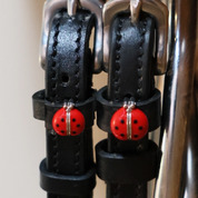 Close-up view of the red lady bug Mane Jane Spur Straps