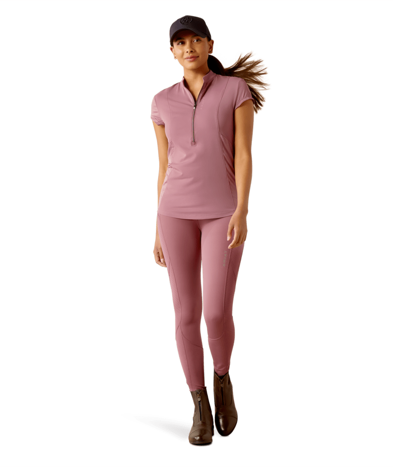Full body front view of a model wearing the tulipwood Ariat Breathe 1/2 Zip Short Sleeve Baselayer and matching tights on a white background