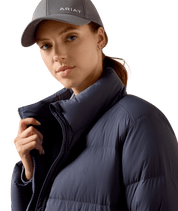 Close-up angled front view of a female model wearing the Odyssey Grey Ariat Ultrapuff Down Jacket on a white background