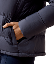 Close-up side view of a female model wearing the Odyssey Grey Ariat Ultrapuff Down Jacket on a white background