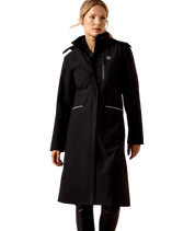 Front view of a female model wearing the Black Ariat Long Rider Waterproof Coat on a white background