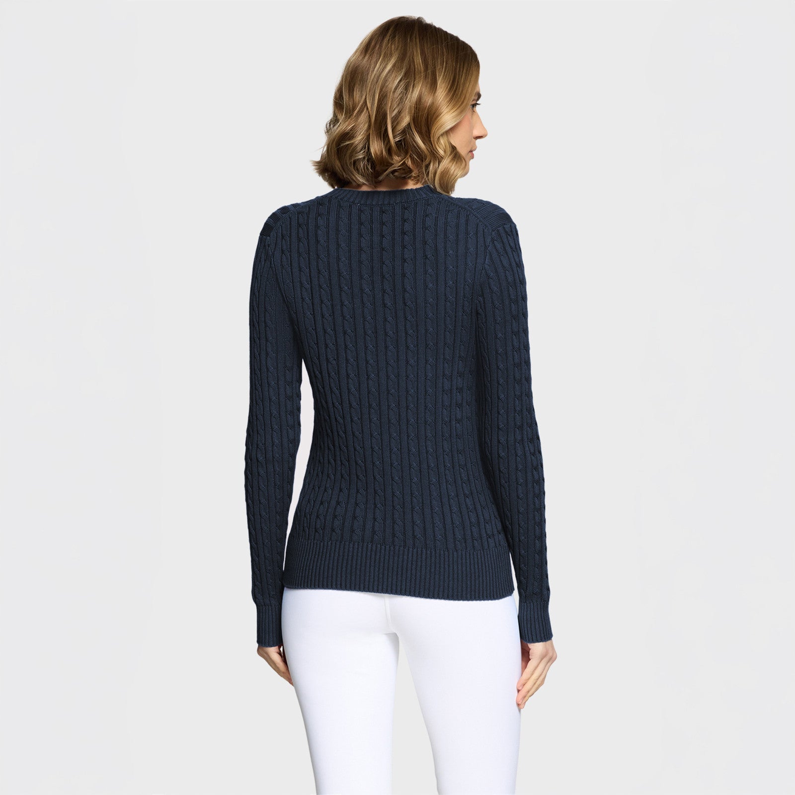 Back view of a female model wearing the Navy Samshield Lisa Twisted Sweater on a plain background