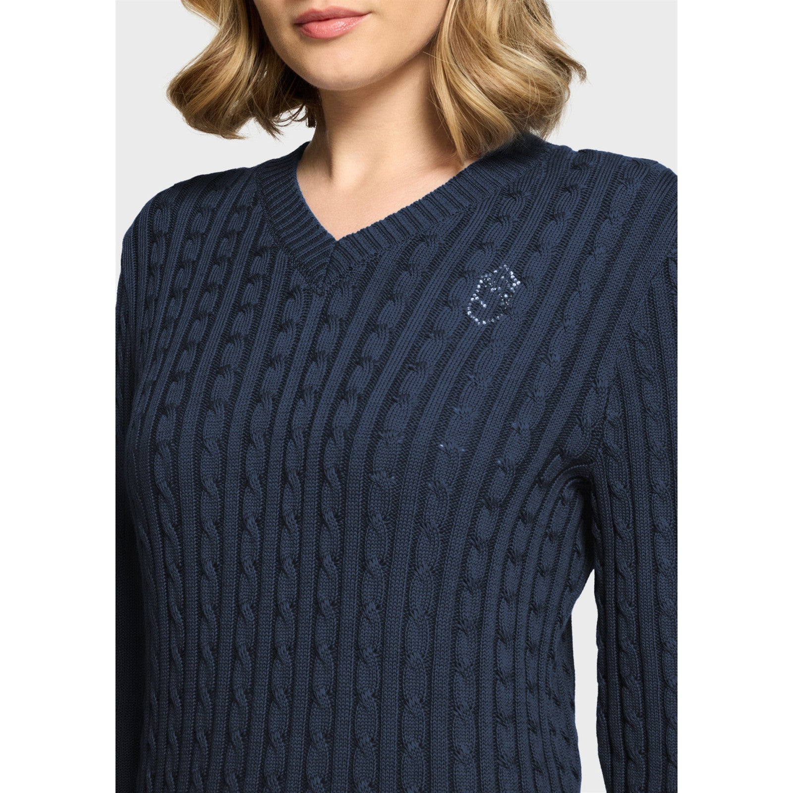 Close-up front view of a female model wearing the Navy Samshield Lisa Twisted Sweater on a plain background