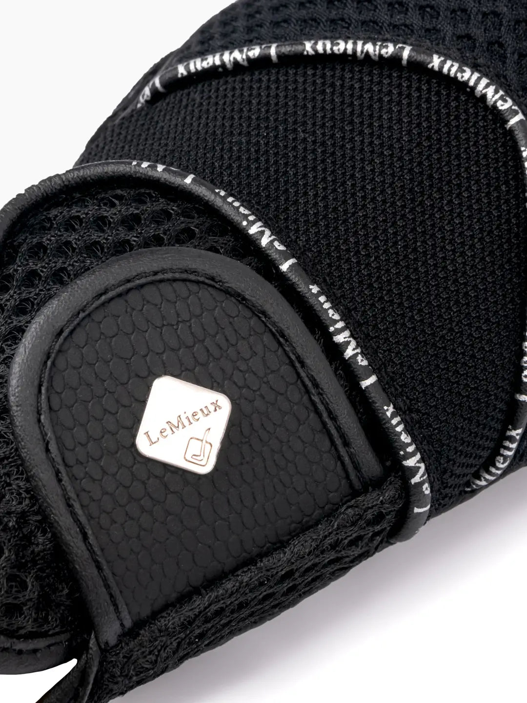 Close-up back view of the velcro closure on the black LeMieux 3D Mesh Riding Gloves