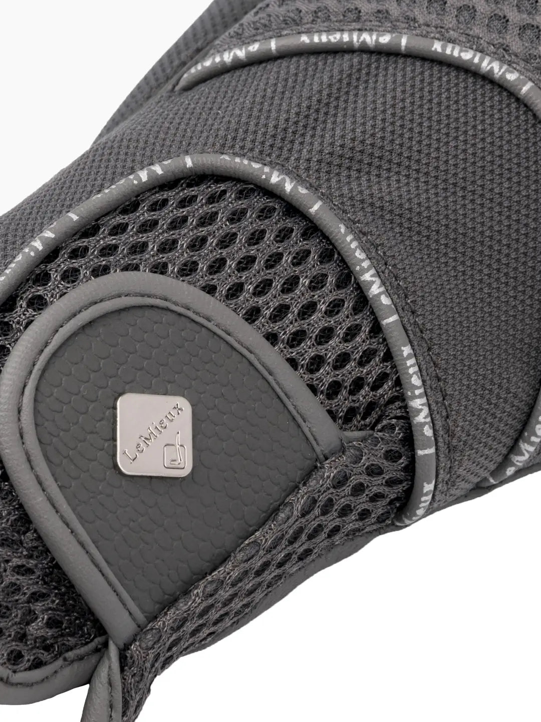 Close-up back view of the velcro closure on the gray LeMieux 3D Mesh Riding Gloves on a white background