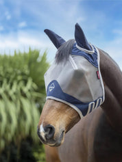 Angled front view of a dark colored horse wearing the navy Lemieux ArmourShield Pro Half Fly Mask outside