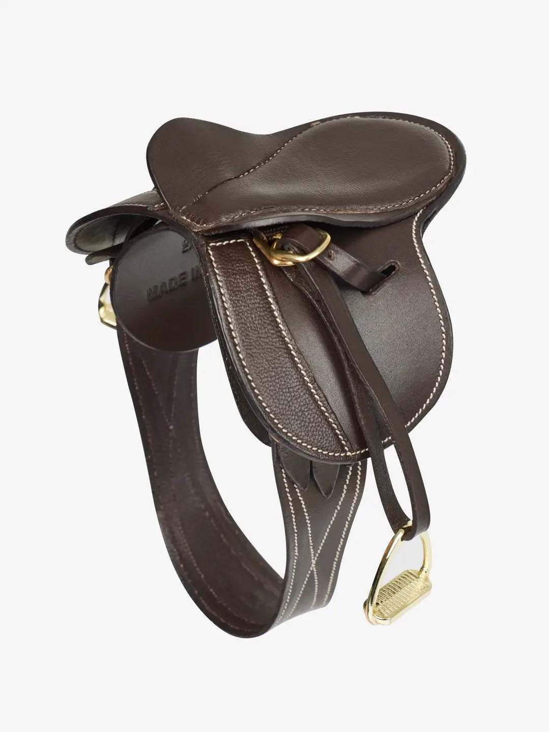 Angled side view of the brown LeMieux Toy Pony Saddle and Girth on a white background