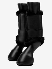 Pair of black LeMieux Fleece Edged Brushing Boots on black plastic horse legs on white background