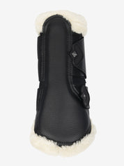 Back view of the black/natural LeMieux Fleece Edged Brushing Boot on a white background