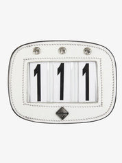 Front view of the white LeMieux Diamante Saddle Number Holder showing 111 on a white background