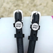Front view of the buckled Long Spot Mane Jane Spur Straps on a pink, purple, and white pole