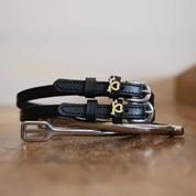 View of the long dog Mane Jane Spur Straps on a wooden surface