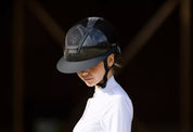 Angled front view of a model wearing the Carbon Freejump Voronoi Helmet on a dark background
