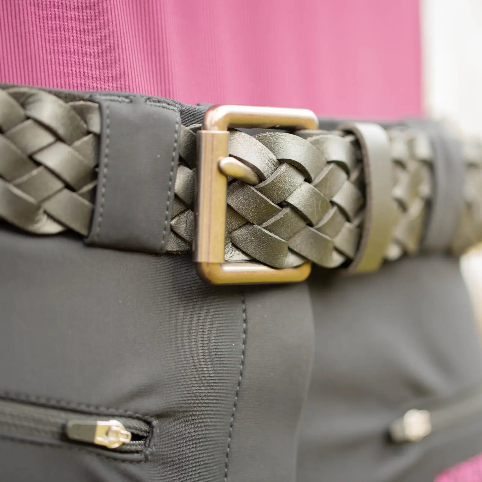 Close-up view of the buckle on the black Equinavia Kari Braided Belt over black breeches