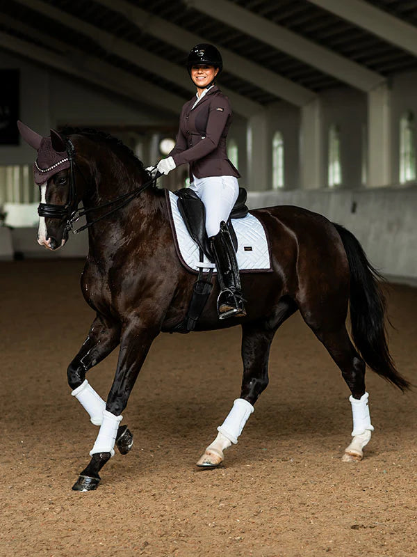 Full view of a female model riding a dark colored horse with a Moonless Night Equestrian Stockholm White Modern Dressage Pad