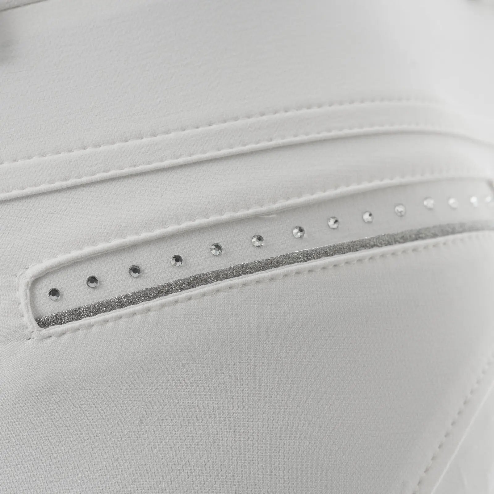 Close-up view of the rhinestone details on the white Equinavia Victoria Full Seat Breeches