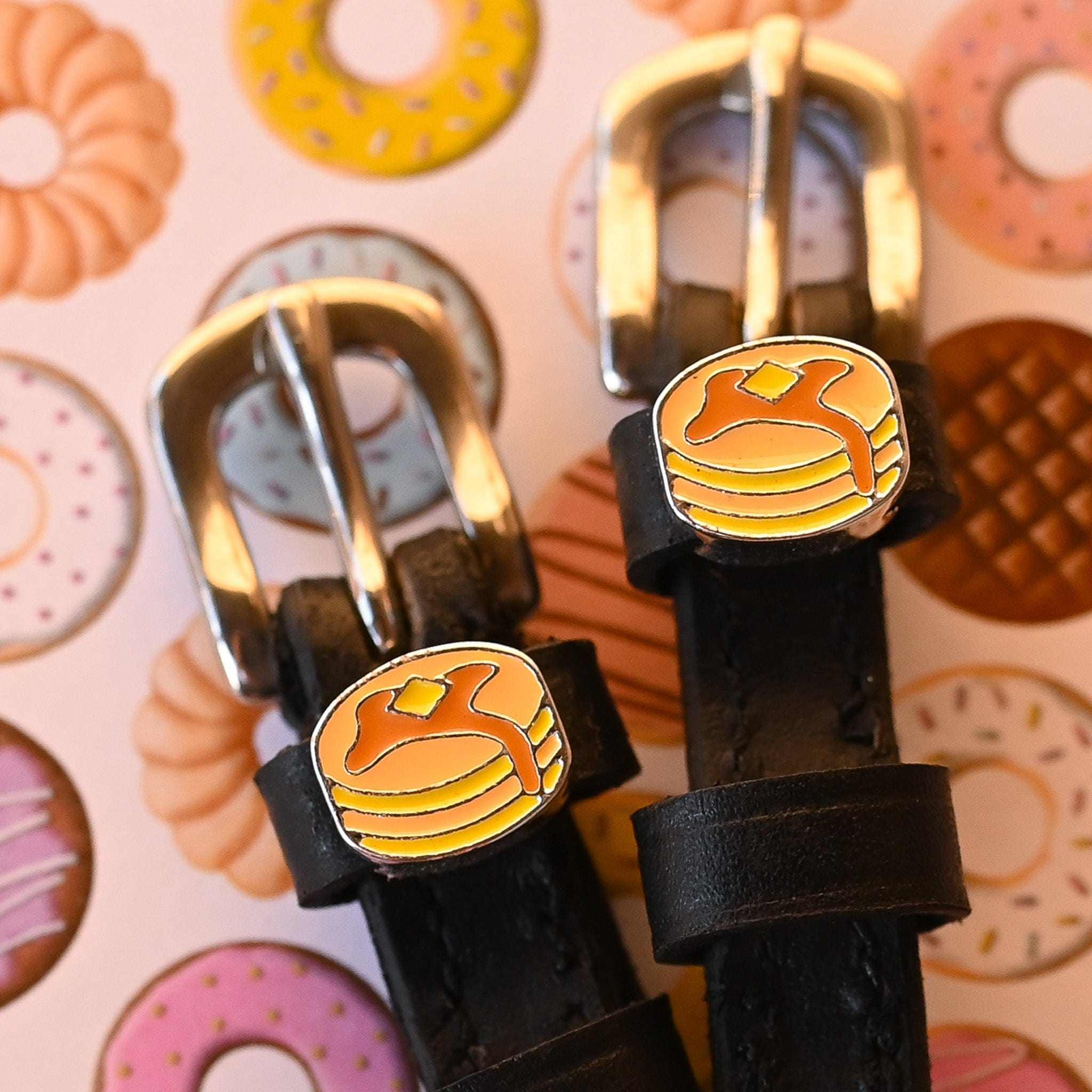Close-up view of the Pancake Mane Jane Spur Straps on a pastry background