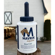 Front view of a 16 oz bottle of Mavrik Hoof Oil with a white barn in the background