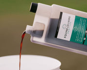 Front view of someone pouring a 30 oz bottle of Equine Elixirs Positude into a white bucket