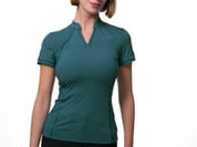 Video of a female model posing while wearing the green LeMieux Lisa Mesh Short Sleeve Base Layer on a plain background