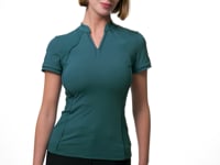 Video of a female model posing while wearing the green LeMieux Lisa Mesh Short Sleeve Base Layer on a plain background