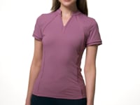 Video of a female model posing in front of a white background while wearing the purple LeMieux Lisa Mesh Short Sleeve Base Layer