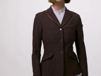 Video showing a female model posing while wearing the brown LeMieux Brilliance Diana Show Jacket on a plain background