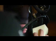 View of someone demonstrating how to use the Carr & Day & Martin Belvoir Tack Cleaner Spray and the Carr & Day & Martin Belvoir Tack Conditioner Spray on tack inside a tack room