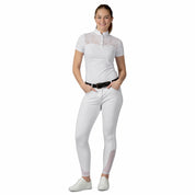 Full body front view of a female model wearing the Equinavia Lisa Lace Short Sleeve Show Shirt and white breeches on a white background