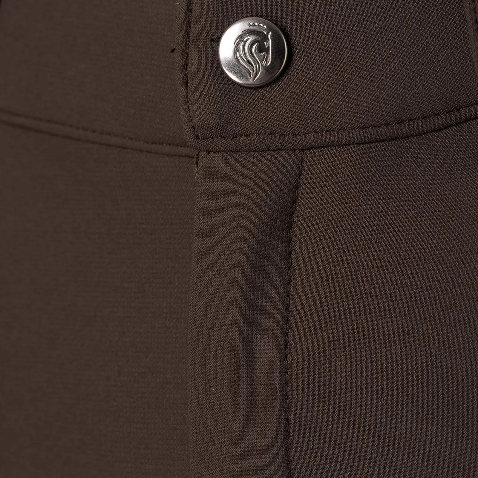 Close-up front view of the button on the brown Equinavia Anders Mens Full Seat Breeches on a white background