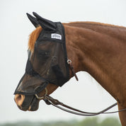 Side view of a chestnut horse wearing the black arabian Cashel Quiet Ride Fly Mask with Long Nose and Ears while standing outside