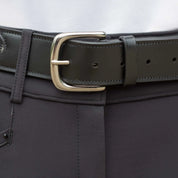 Close-up view of the buckle on the black Equinavia Erika Crystal Bit Belt over black breeches