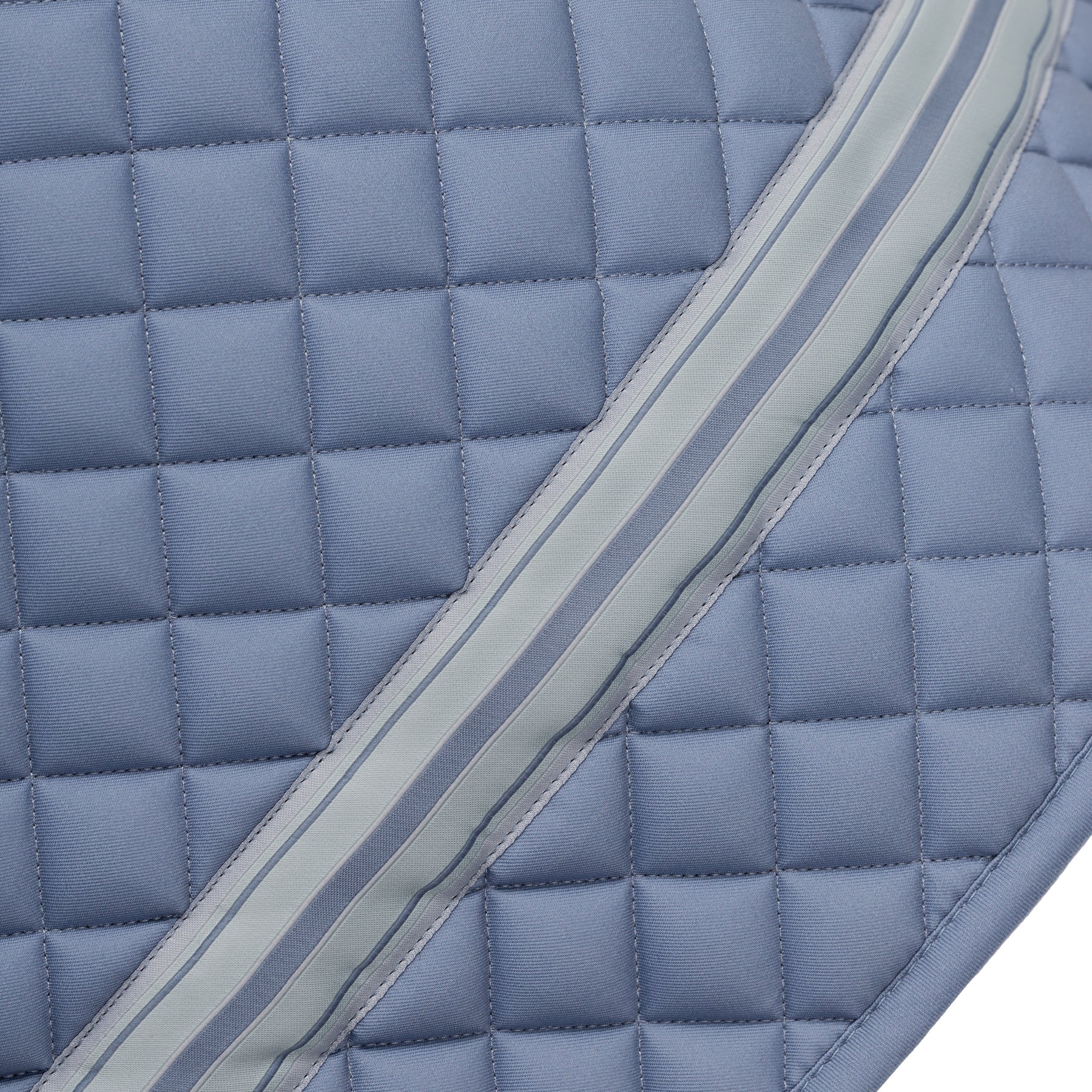 Side closeup view of Dusk Blue Equinavia Harstad Ribbon Dressage Pad on a white background