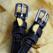 Close-up view of the Taco Mane Jane Spur Straps on a tortilla chip background