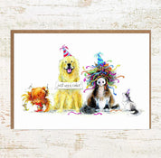 View of the Just Need Cake Cat, Chicken, Dog and Pony Pony Nut Greeting Card on a white washed wood background