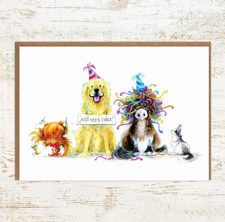 View of the Just Need Cake Cat, Chicken, Dog and Pony Pony Nut Greeting Card on a white washed wood background