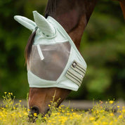 Side view of horse grazing wearing the Equinavia Algard Soft Mesh Fly Mask in Misty Jade