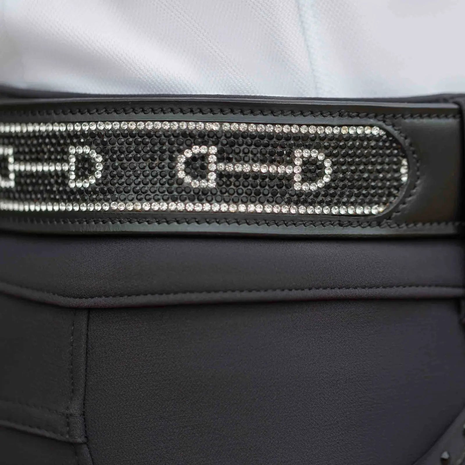 Close-up view of the black Equinavia Erika Crystal Bit Belt over black breeches