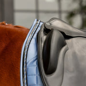 Side closeup view of a horse wearing Dusk Blue Equinavia Copenhagen Stay Put Dressage Saddle Pad