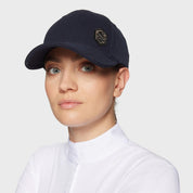 Angled front view of a female model wearing the navy Samshield Sadie Pearl Metal Eclipse Cap on a plain background